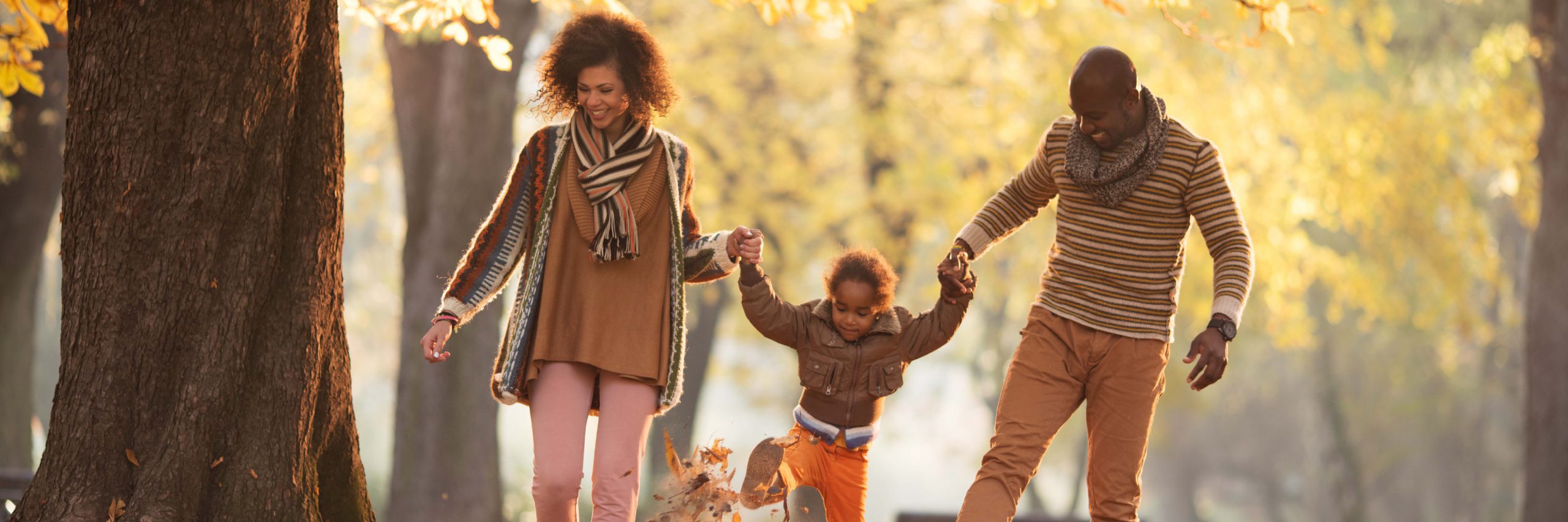 Fun autumn family holding hands