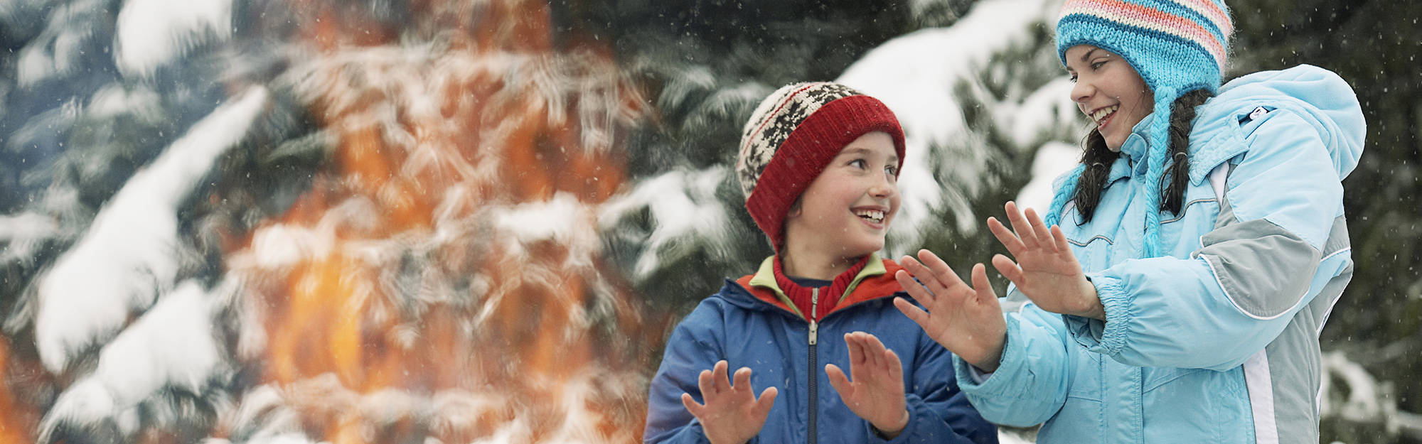 Children warming hands by a fire